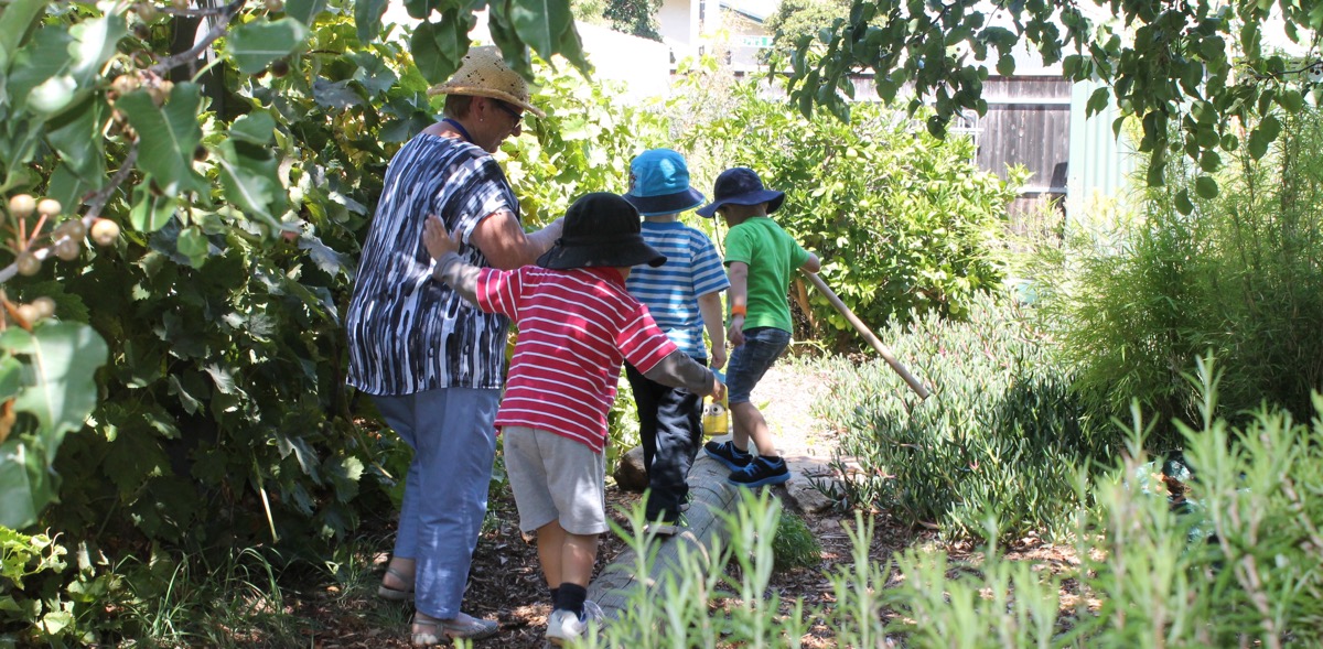 Preschool students with teacher walking on log