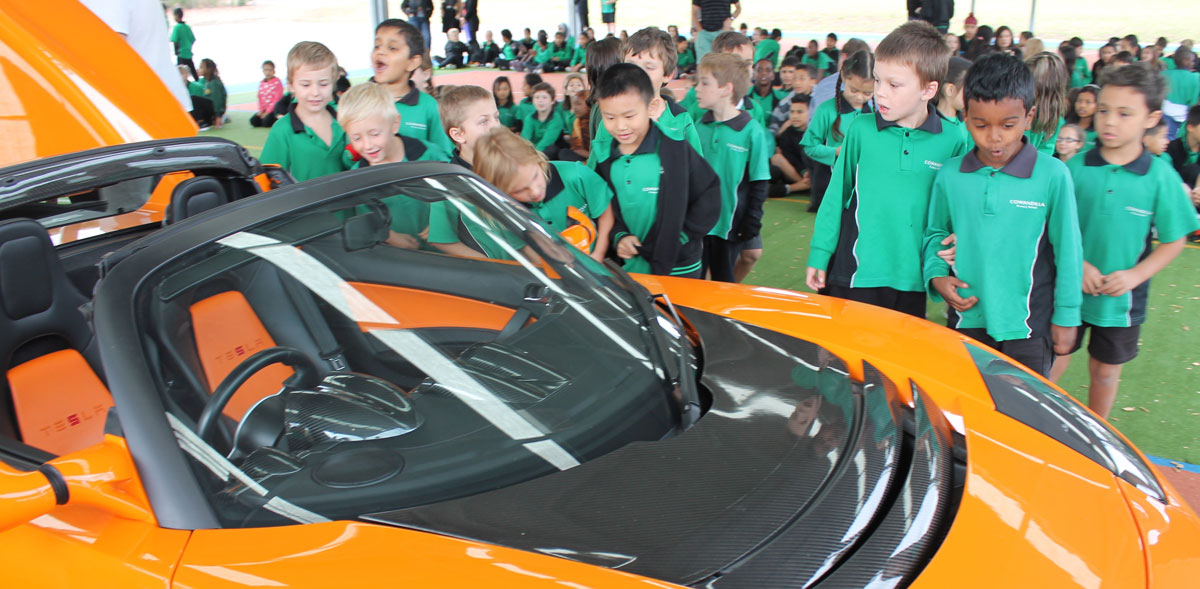 Students with an electric car