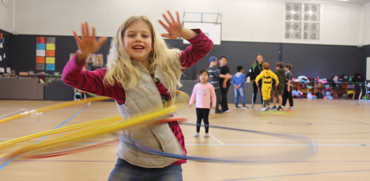 Child playing with a hoop