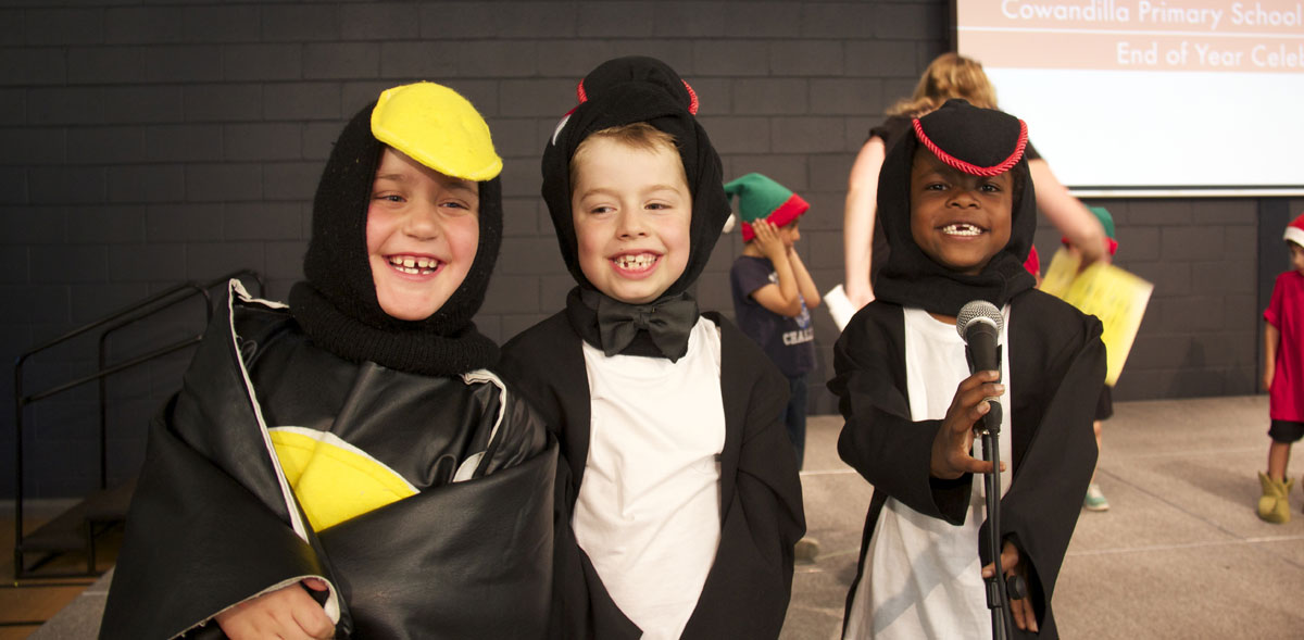 Students dressed up as penguins at school concert