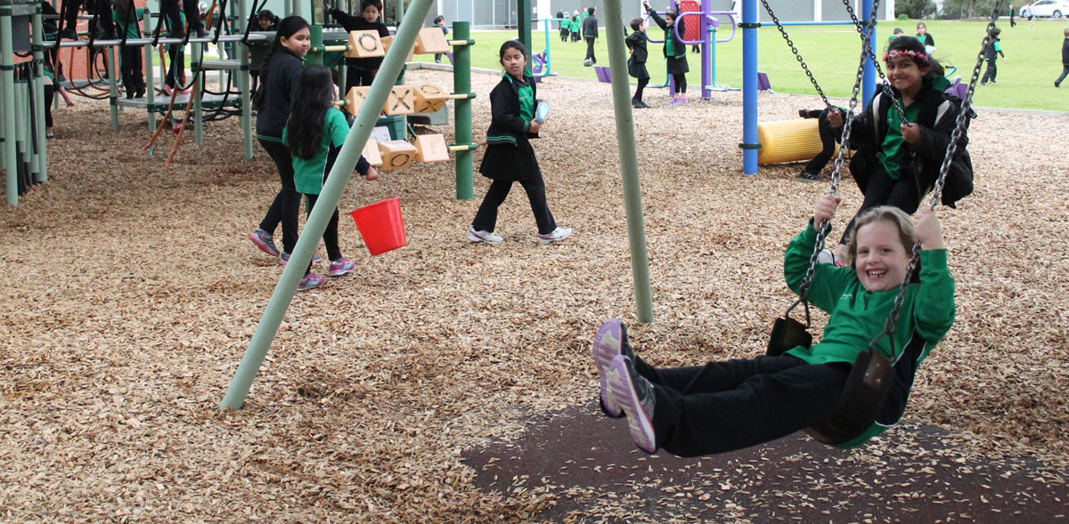 Students playing on swings